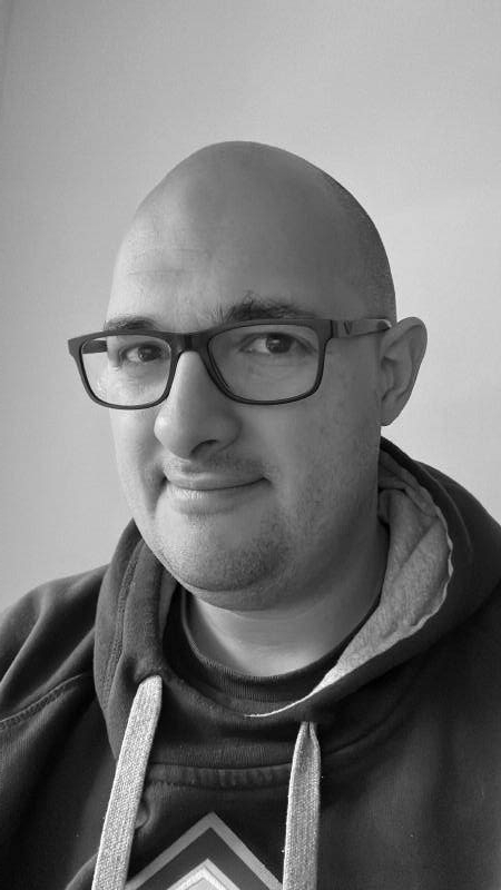 A selfie of the author, in grayscale.