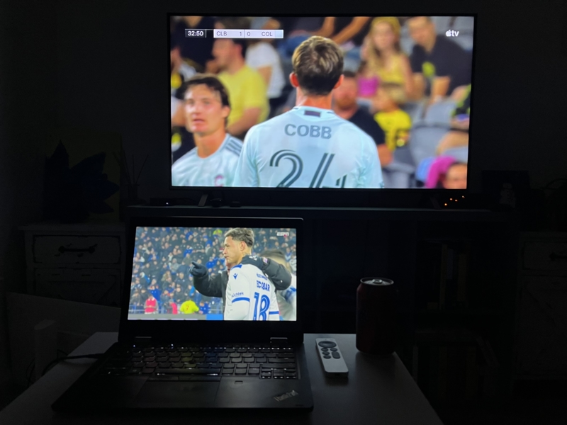 A laptop and a TV, each displaying a different football match.