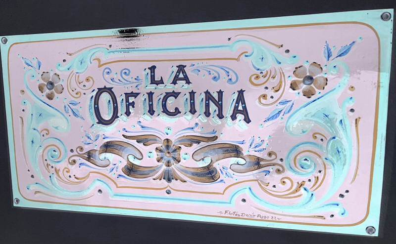 Photo of a handpainted sign, with inverted colors.